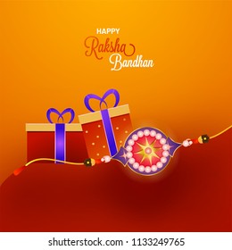 Shiny Rakhi With Gift Boxes On Orange And Red Background For Raksha Bandhan Celebration Concept.