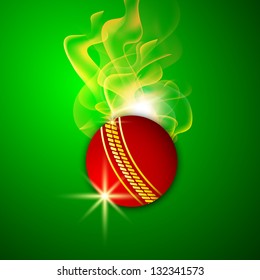 Shiny red cricket ball in flame on green background.