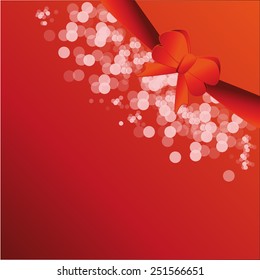 Shiny red satin ribbon on red background