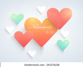 Shiny romantic colorful love hearts for Happy Valentine's Day celebration on sky blue background.