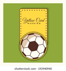 Shiny soccer ball with foul yellow card on green background. 