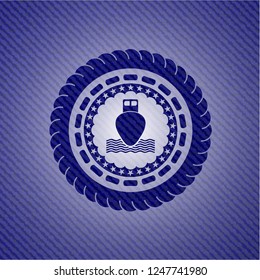 ship icon inside emblem with denim texture