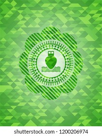 ship icon inside realistic green mosaic emblem