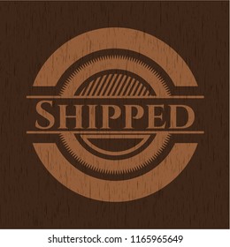 Shipped badge with wooden background