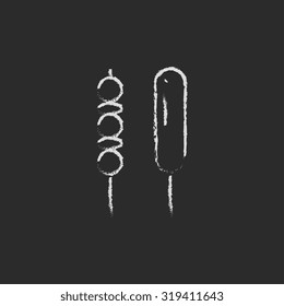 Shish kebab hand drawn in chalk on a blackboard vector white icon isolated on a black background.