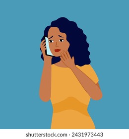 Shocked Black woman talking on mobile phone with fear and anxiety. African American girl using smartphone with amazing expression.