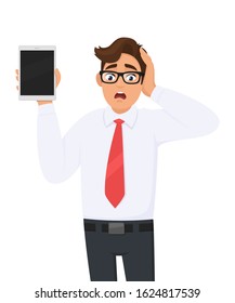 Shocked businessman showing new tablet computer and holding head with hand. Stressed person holding digital tab. Male character illustration. Modern technology, lifestyle concept in vector cartoon.