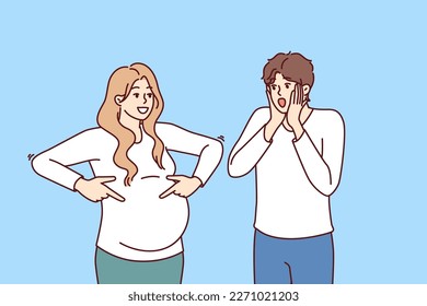 Shocked man is surprised to see pregnant woman and does not want to become father or take girl as wife. Pregnant lady pointing fingers at belly for concept of using contraceptives.