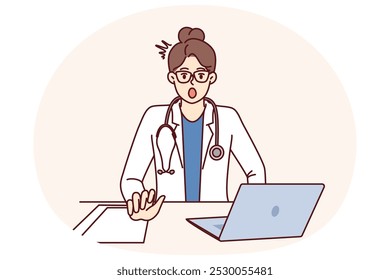 Shocked woman doctor is surprised to see rare disease, sits at table with laptop. Girl doctor with stethoscope, opening mouth looks at screen after learning about symptoms of mysterious disease