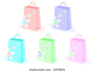 Shopping bags decorated with flowers over white background