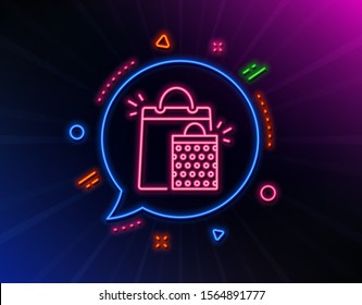 Shopping bags line icon. Neon laser lights. Sale Marketing symbol. Special offer sign. Glow laser speech bubble. Neon lights chat bubble. Banner badge with shopping bags icon. Vector