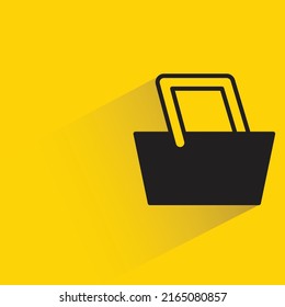 shopping basket with shadow on yellow background