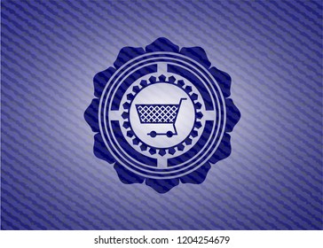 shopping cart icon inside badge with denim texture