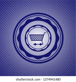 shopping cart icon inside badge with denim background