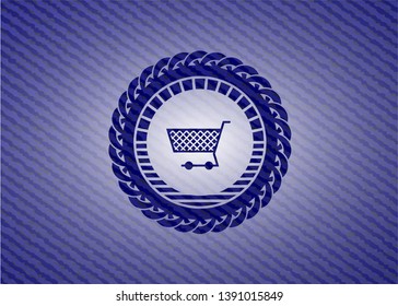shopping cart icon inside badge with denim texture