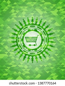 shopping cart icon inside green emblem with triangle mosaic background