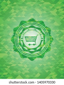 shopping cart icon inside green emblem. Mosaic background