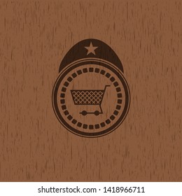shopping cart icon inside vintage wood emblem
