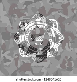 shopping cart icon on grey camouflaged texture
