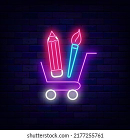 Shopping cart with pencil and brush neon sign. Office store label. School concept. Education emblem. Back to school design. Glowing advertising on brick wall. Vector stock illustration