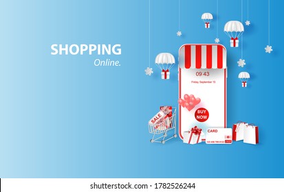 Shopping Online on smartphone or Mobile Application Concept idea Marketing and Digital marketing. Merry Christmas background Horizontal view with gift box and parachute of content sale in holiday