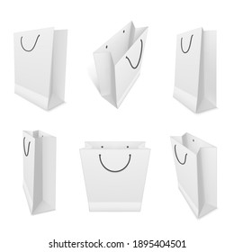 Shopping paper bags realistic mockups set. White blank packaging with rope handles templates. Top, side, three quater view. Ready for your design. Vector isolated bags illustration.