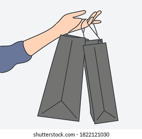 Shopping, sale, choice, store, buy concept. Human character hand holding shopping bags. Hand drawn in thin line style, vector illustrations.