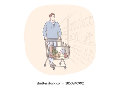 Shopping, supermarket, grocery store concept. Young positive man cartoon character walking along shelves in supermarket with trolley cart with fresh products inside and choosing food ingredients 