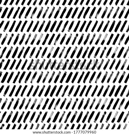 Short diagonal lines hand drawn seamless pattern. Grunge ink brush vector texture. Black paint dry brushstrokes. Freehand textured drawing. Abstract background design. Textile, wrapping paper.