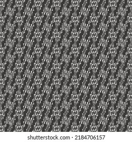 Short slanted stripes on a background decorated with miniature elements. Abstract tapestry texture. Graphics in black and white.