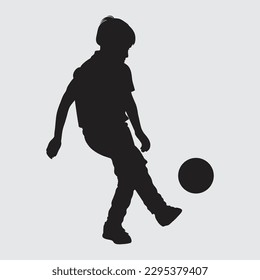 shot of a little boy playing soccer isolated In silhouette