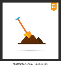 Shovel in heap of soil