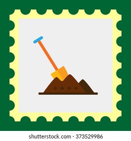 Shovel in heap of soil