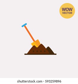 Shovel in heap of soil