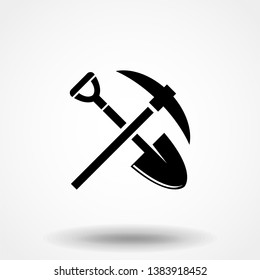 Shovel and pickaxe icon. Black icon isolated on white background. Shovel and pick axe silhouette. Simple icon. Web site page and mobile app design vector element.
