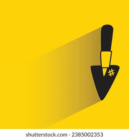 shovel with shadow on yellow background