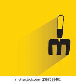 shovel with shadow on yellow background