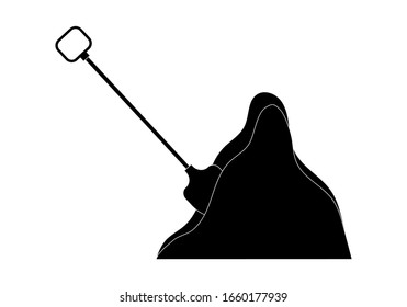Shovel stuck in a pile of dirt.