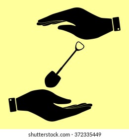 Shovel to work in the garden. Save or protect symbol by hands.