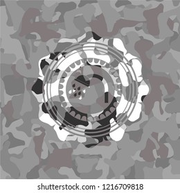 shower icon inside grey camouflaged emblem