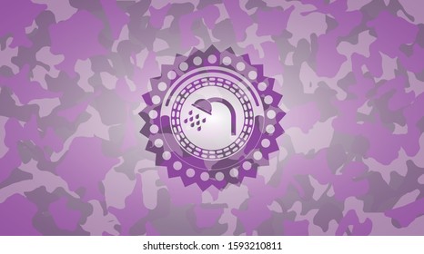 shower icon inside pink camouflaged emblem
