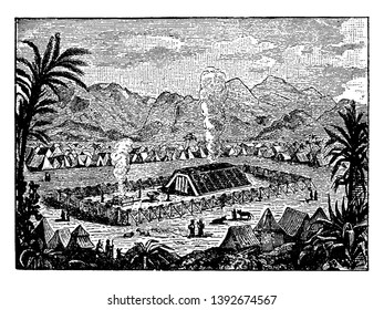 It shows aerial view of town, tents, few people and animals, altar, trees and mountains in background, vintage line drawing or engraving illustration