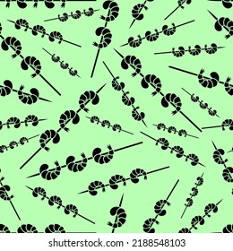 Shrimps on a skewer. Silhouette. Seamless vector pattern. Repeating background of seafood prepared for grilling. Endless shrimp tail ornament. Isolated green background. Idea for web design.