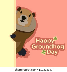 A shy groundhog hides behind the yellow wall to send a greeting for Groundhog Day