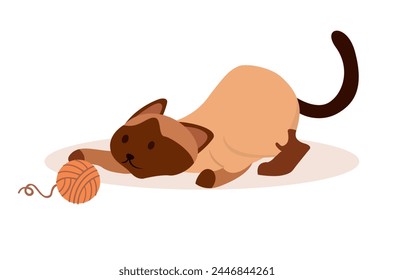 Siamese cat playing with a woolen yarn ball