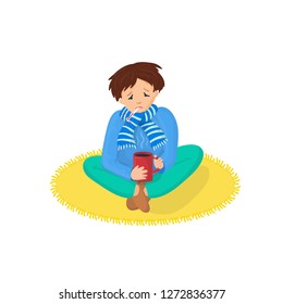 Sick boy with hot tea and thermometer, at warm scarf. Guy having a cold, holding a cup, symptoms of flu