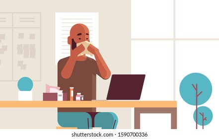 sick businessman blowing nose with handkerchief african american guy sitting at workplace using laptop man having flu sneeze illness concept modern office interior portrait horizontal vector