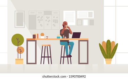 sick businessman blowing nose with handkerchief african american guy sitting at workplace using laptop man having flu sneeze illness concept modern office interior full length horizontal vector