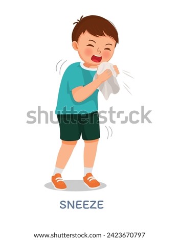 Sick little boy suffering from flu or cold allergy symptom sneezing on a handkerchief or tissue paper
