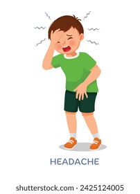 Sick little boy suffering from headache or migraine touching his forehead